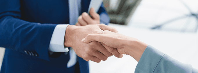 Vehicle Registration Taxes and Fees at Washington Honda in Washington, PA | Man in blue suit is shaking hands with a woman