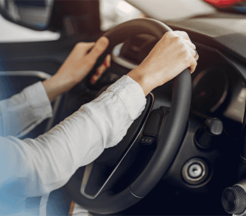 Defining GAP Insurance at Washington Honda in Washington, PA | Person's hand on the steering wheel of a car with black interior