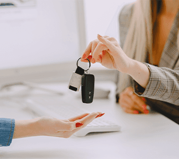 Defining GAP Insurance at Washington Honda in Washington, PA | Sales person handing over new car keys to a woman with red colored nails