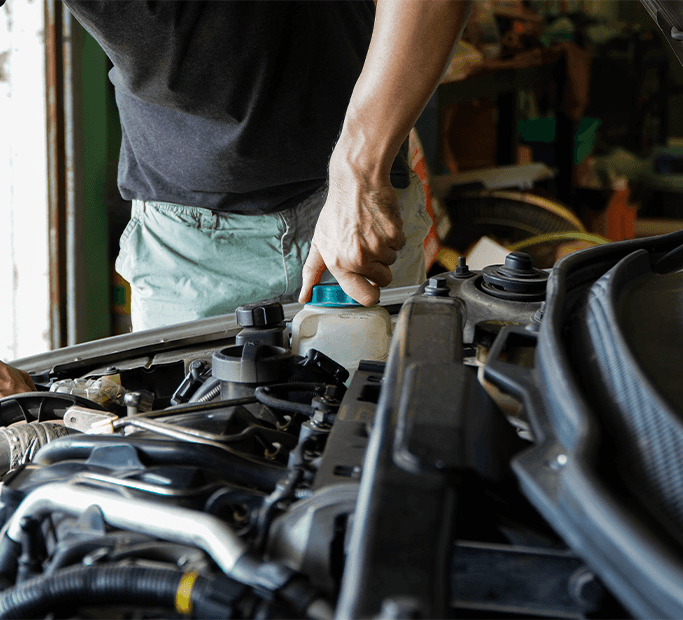 How to Get Your Car Summer Ready at Washington Honda in Washington, PA | Man in black shirt opening the lid of a coolant reservoir