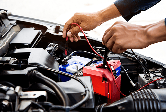 How to Get Your Car Summer Ready at Washington Honda in Washington, PA | Person checking the battery life of a car battery by using a volt checker