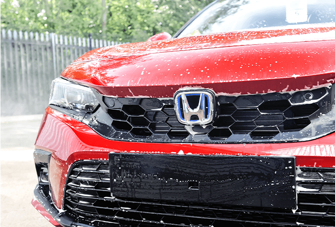 How to Get Your Car Summer Ready at Washington Honda in Washington, PA | Red Honda Civic with soap and water dripping off