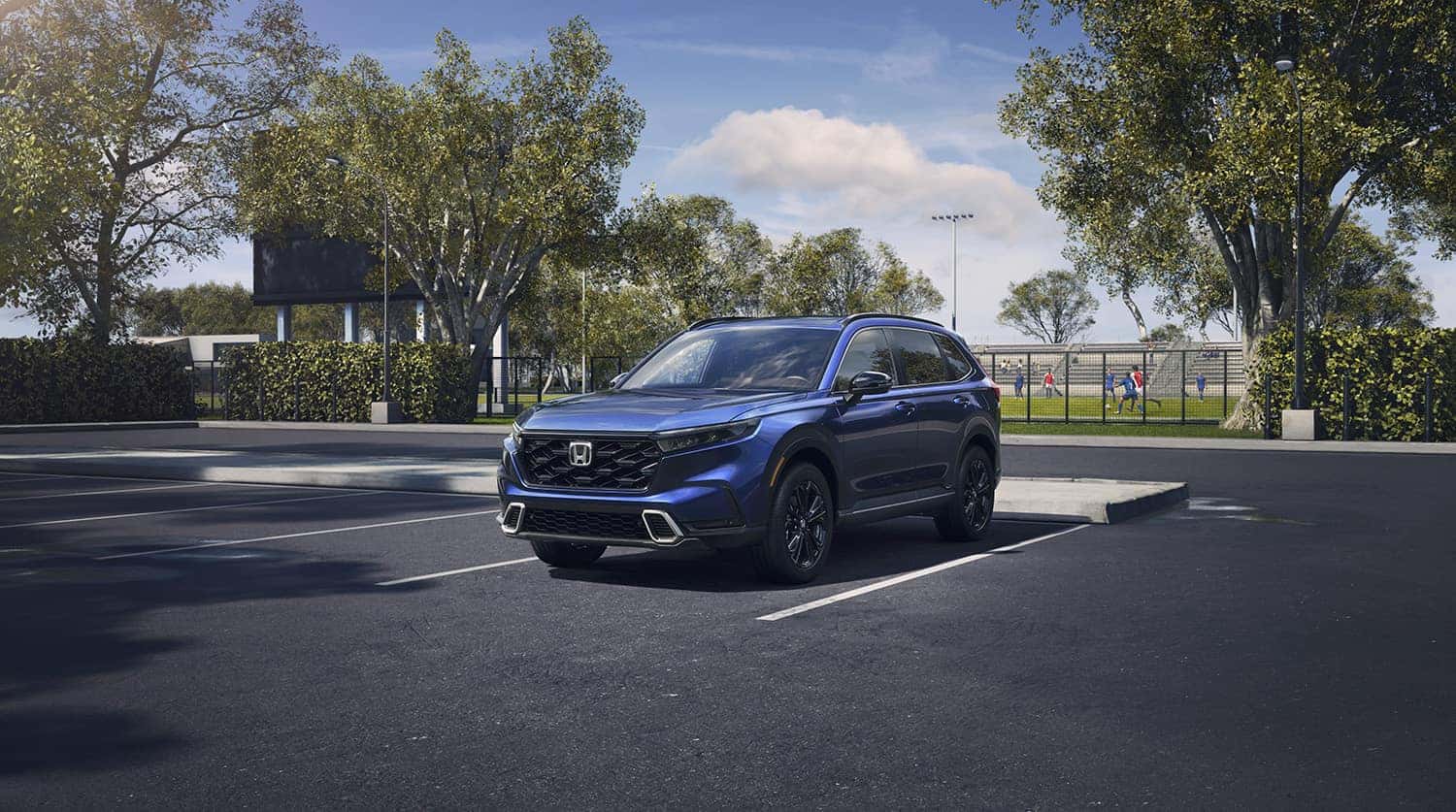 New 2023 Honda CR-V at Washington Honda | 2023 Honda CR-V parked in a parking lot by a soccer field