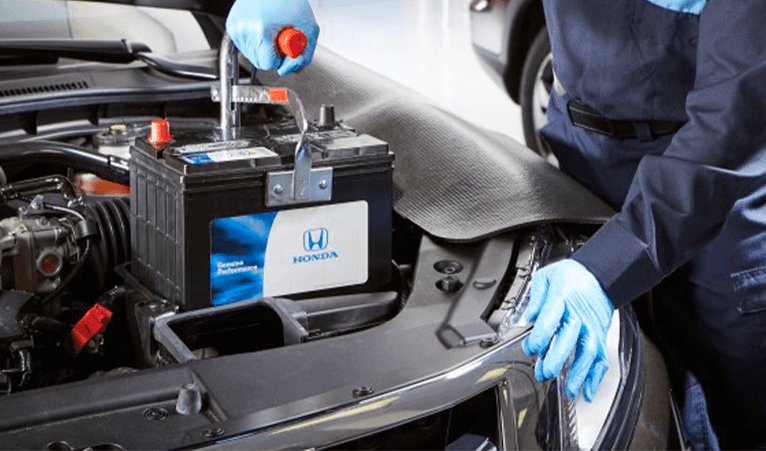 Everything You Need to Know about Your Car Battery at Washington Honda | Honda mechanic installing new car battery into vehicle