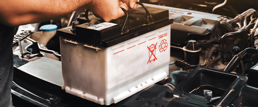Everything You Need to Know about Your Car Battery at Washington Honda | Person taking out a used car battery out of car 